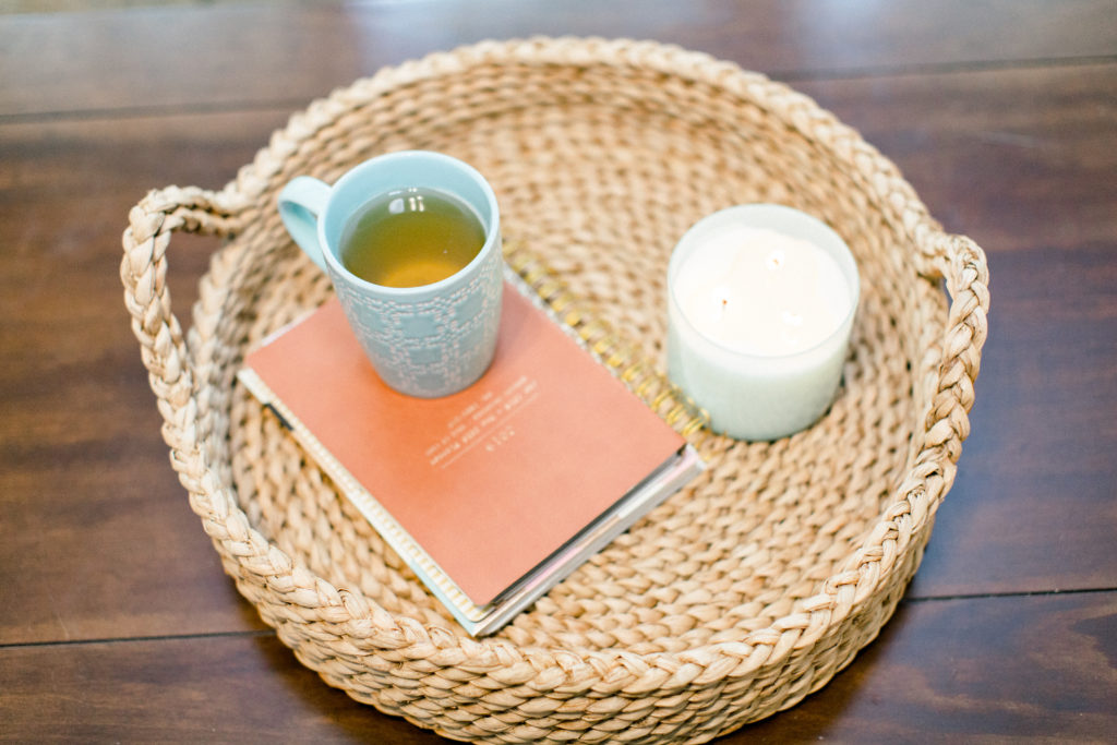 Tea, notebook and candle in a beige basket